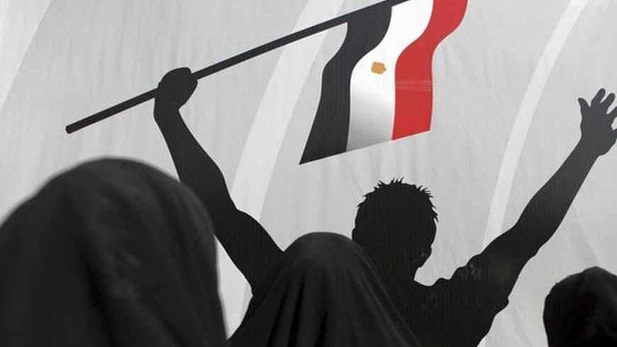 Members of the Muslim Brotherhood and supporters of deposed Egyptian President Mohamed Mursi pray in front of a poster during a funeral for two people killed in recent clashes at Rabaa Adawiya Square, where they are camping in Nasr city area, east of Cairo August 1, 2013.  Egypt's army-backed government on Thursday urged supporters of deposed president Mohamed Mursi to abandon their Cairo protest camps, promising them a safe exit if they gave up without a fight. REUTERS/Amr Abdallah Dalsh  (EGYPT - Tags: PO