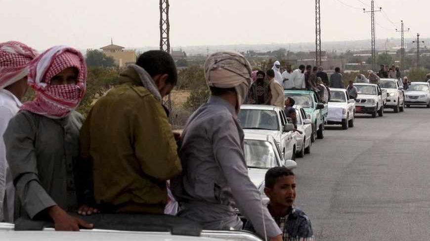 A funeral convoy carrying the bodies of four Islamist militants drives through Sheikh Zuweid, in the north of the Sinai peninsula, August 10, 2013. The four Islamist militants were killed by an air strike that their comrades said had been done by an Israeli drone but which state media said was the work of an Egyptian army helicopter. REUTERS/ Stringer (EGYPT - Tags: CIVIL UNREST POLITICS) - RTX12G5D