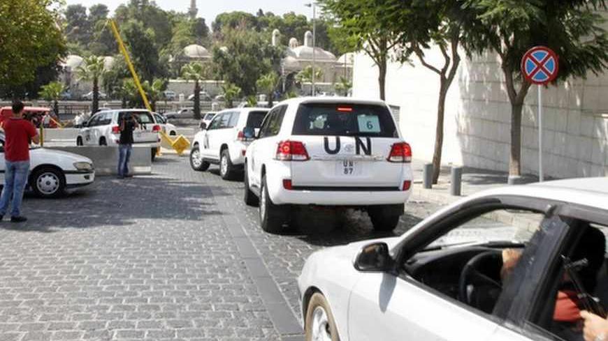 United Nations (U.N.) vehicles transport a team of U.N. chemical weapons experts to the scene of a poison gas attack outside the Syrian capital last week, in Damascus August 26, 2013. The experts dressed in blue U.N. body armour, left in a six-car convoy, according to a Reuters witness, and were accompanied by security forces and an ambulance. They said they were headed to the rebel-held outskirts of Damascus, known as Eastern Ghouta, where activists say rockets loaded with poison gas killed hundreds of peo