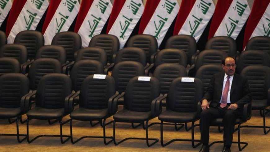 Iraq's Prime Minister Nuri al-Maliki waits to take an oath at the house of parliament in Baghdad December 21, 2010. Iraq's parliament approved Nuri al-Maliki as prime minister on Tuesday, giving the Shi'ite leader a second term as Iraq tries to cement fragile security gains and build its fledging democracy.  REUTERS/Saad Shalash (IRAQ - Tags: POLITICS IMAGES OF THE DAY) - RTXVXLT