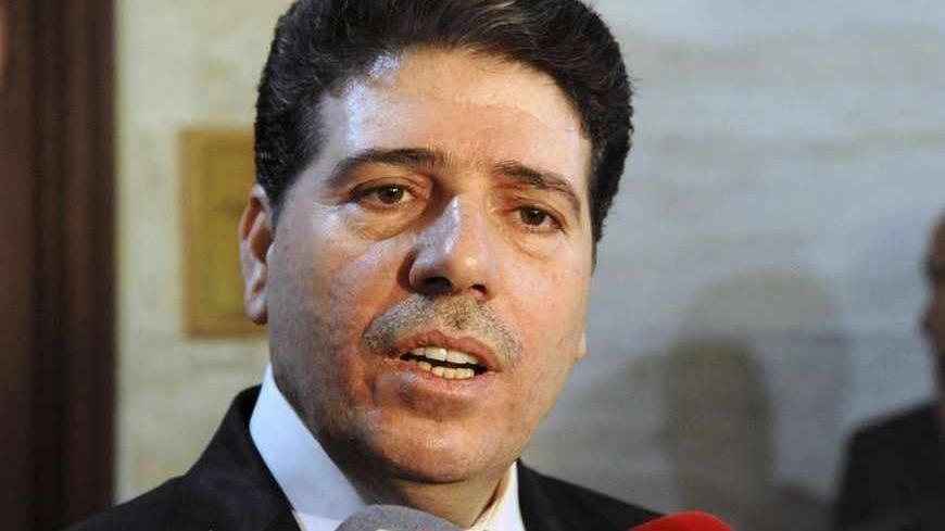 Syrian Prime Minister Wael al-Halki talks to media in Damascus April 29, 2013, in this handout photograph distributed by Syria's national news agency SANA. Al-Halki survived a bomb attack on his convoy in Damascus on Monday, state media and activists said, as rebels struck in the heart of President Bashar al-Assad's capital. The Britain-based Syria Observatory for Human Rights, which has a network of sources across Syria, said one person accompanying the prime minister had been killed. State television repo