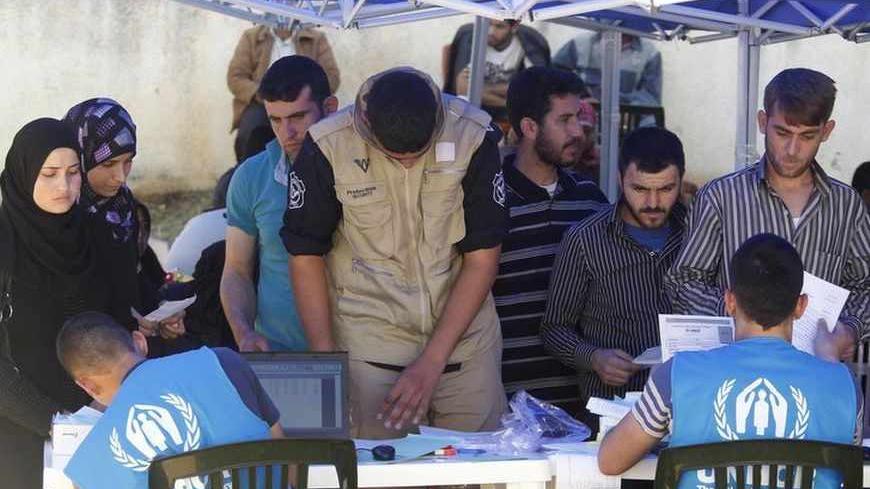 Syrian and Palestinian refugees register their names in order to receive humanitarian aid at the Offices of the United Nations High Commissioner for Refugees (UNHCR) in Beirut April 29, 2013. REUTERS/Sharif Karim  (LEBANON - Tags: POLITICS) - RTXZ3F9