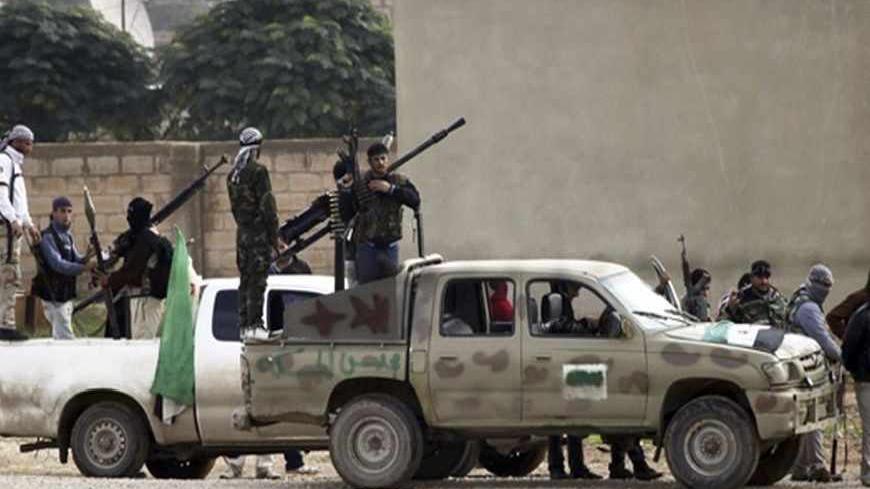 Members of the Free Syrian Army gather as gunfire is heard between them and the armed Kurds of The Kurdish Democratic Union Party (PYD) in the northern Syrian town of Ras al-Ain, November 25, 2012. Iran said Turkey's plans to deploy Patriot defensive missiles near its border with Syria would add to the region's problems, as fears grow of the Syrian civil war spilling across frontiers. REUTERS/Amr Abdallah Dalsh  (TURKEY - Tags: POLITICS CONFLICT) - RTR3AV5G