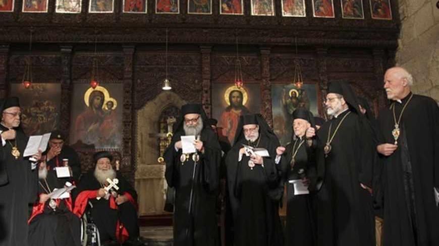 Greek Orthodox Patriarch John Yazigi (C) leads a prayer at the Balamand Monastery in Koura, near the north Lebanese city of Tripoli, to call for the release of bishops kidnapped in northern Syria two months ago, June 22, 2013. Patriarch John Yazigi led the candle-lit vigil on Saturday for Greek Orthodox archbishop Paul Yazigi and Syriac Orthodox archbishop Yohanna Ibrahim, appealing to their kidnappers to free them and urging Syrian security forces to do more to win their release. REUTERS/Omar Ibrahim (LEBA