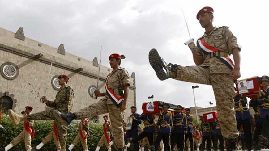 An honour guard carries coffins of military personnel killed after tribal militants shot down a military helicopter In Marib province, 173 km east of the capital Sanaa. August 7, 2013. REUTERS/Mohamed al-Sayaghi (YEMEN - Tags: MILITARY OBITUARY) - RTX12CV5