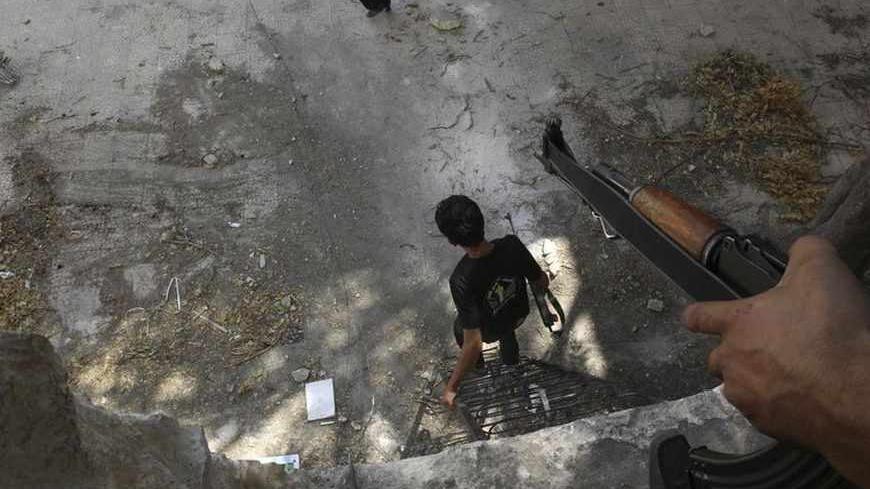 A Free Syrian Army fighter goes down a ladder near Aleppo's historical citadel in the old city of Aleppo August 23, 2013. REUTERS/Muzaffar Salman (SYRIA - Tags: CONFLICT POLITICS) - RTX12UCK