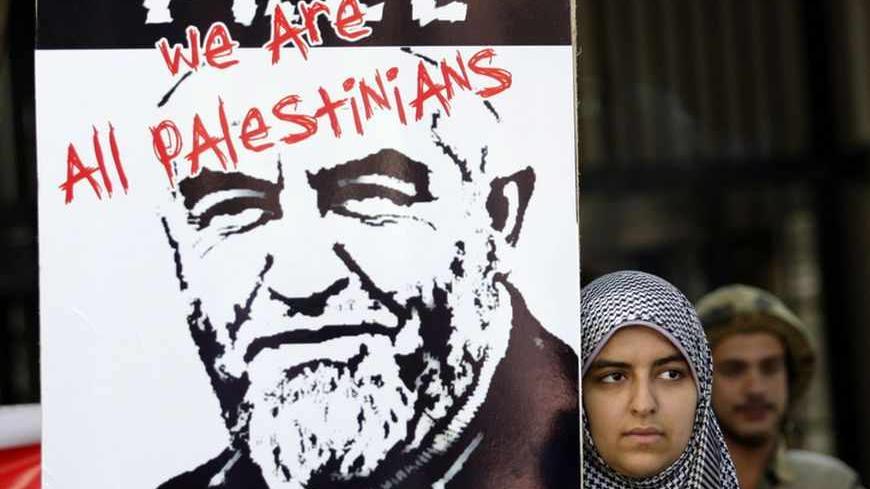 A woman participates in a silent protest held by the Arab Doctors Union outside the British Embassy in Cairo July 12, 2011. The protesters demanded the release of Sheikh Raed Salah, leader of the northern branch of the Islamic Movement in the Palestinian Territories and Imam of Al-Aqsa mosque, who has been detained in London on charges of entering Britain illegally. REUTERS/MOHAMED ABD EL-GHANY (EGYPT - Tags: CIVIL UNREST POLITICS RELIGION) - RTR2OSIA