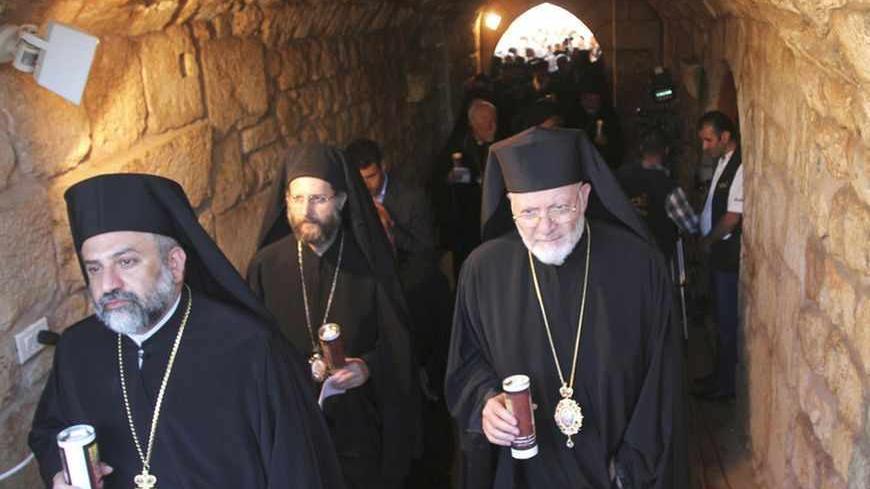 Christian clerics hold candles during a candle-lit vigil at the Balamand Monastery in Koura, near the north Lebanese city of Tripoli, to call for the release of bishops kidnapped in northern Syria two months ago, June 22, 2013. Greek Orthodox Patriarch John Yazigi led the candle-lit vigil on Saturday for Greek Orthodox archbishop Paul Yazigi and Syriac Orthodox archbishop Yohanna Ibrahim, appealing to their kidnappers to free them and urging Syrian security forces to do more to win their release. REUTERS/Om