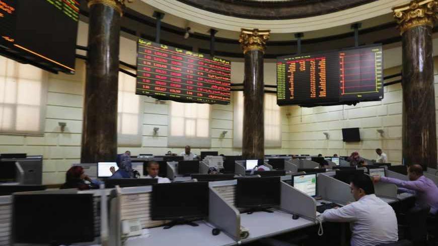 Traders work at the Egyptian stock exchange in Cairo August 18, 2013. Egypt's stock market fell sharply on Sunday as it resumed trading after hundreds of people were killed in a crackdown by the army-backed government on supporters of the Muslim Brotherhood. Banks and the stock market reopened for the first time since Wednesday's carnage, with shares rapidly falling 2.5 percent.  REUTERS/Louafi Larbi (EGYPT - Tags: POLITICS CIVIL UNREST BUSINESS) - RTX12PJR