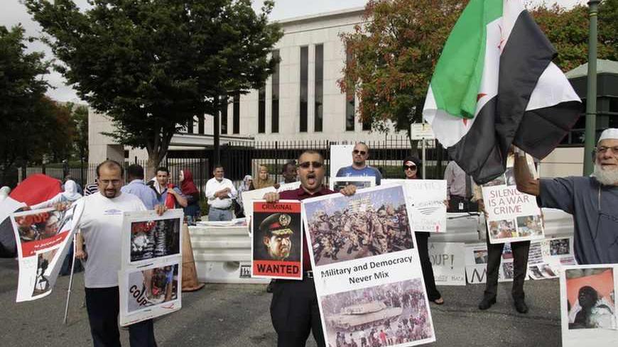 Activists from the Egyptian-Americans for Democracy and Human Rights organization protest outside the Egypt embassy in Washington August 19, 2013. REUTERS/Yuri Gripas (UNITED STATES - Tags: POLITICS CIVIL UNREST) - RTX12R5T