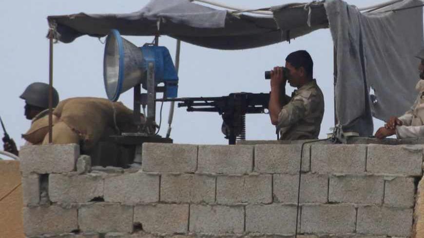 Egyptian soldiers keep guard on the border between Egypt and the southern Gaza Strip September 3, 2013. Egyptian security forces have destroyed some 20 houses along the border with Gaza, local residents said on Tuesday, in what the Palestinian enclave's Islamist Hamas rulers fear is an effort to build a buffer zone to isolate them. 
REUTERS/Ibraheem Abu Mustafa (EGYPT - Tags: POLITICS) - RTX135NK