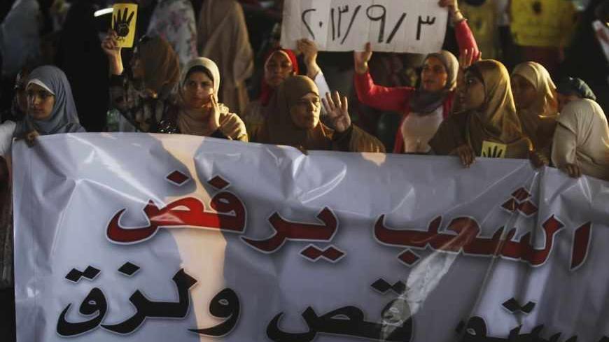 Members of the Muslim Brotherhood and supporters of ousted Egyptian President Mohamed Mursi protest against the military and interior ministry, as they show the "Rabaa" or "four" gesture, in reference to the police clearing of Rabaa al-Adawiya protest camp on August 14, in the southern suburb of Maadi September 3, 2013. An Egyptian military court sentenced supporters of Mursi to long jail terms on Tuesday on charges of attacking soldiers in the city of Suez, a military statement said. More than 1,000 people