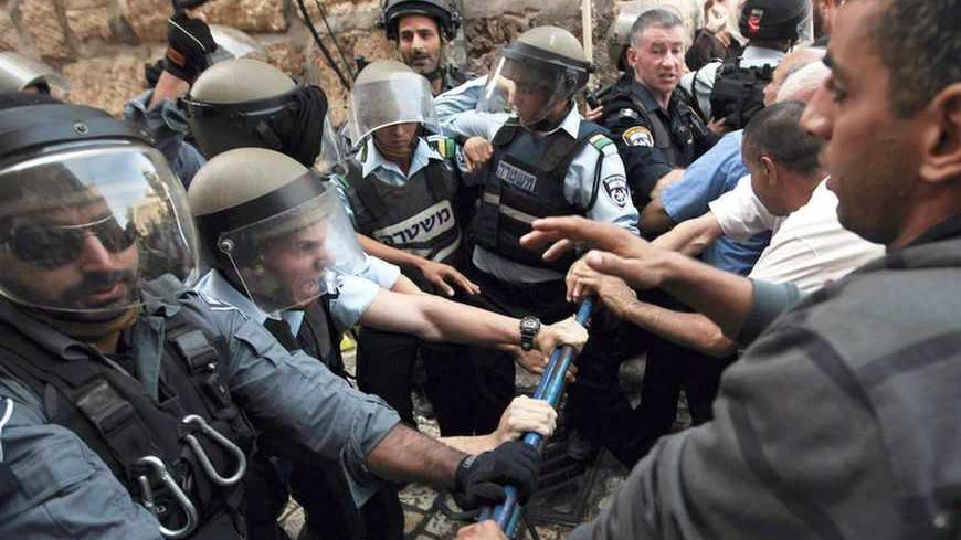 Israeli policemen attempt to maintain order during a demonstration by Palestinians near Lion's Gate in Jerusalem's Old City, as minor clashes take place at a nearby compound known to Muslims as Noble Sanctuary and to Jews as Temple Mount September 4, 2013. An Israeli police spokesperson said five people were detained on Wednesday for throwing stones at police who had entered the compound after stones were thrown at visitors at the holy site ahead of the Jewish new year, or Rosh Hashanah, which begins today
