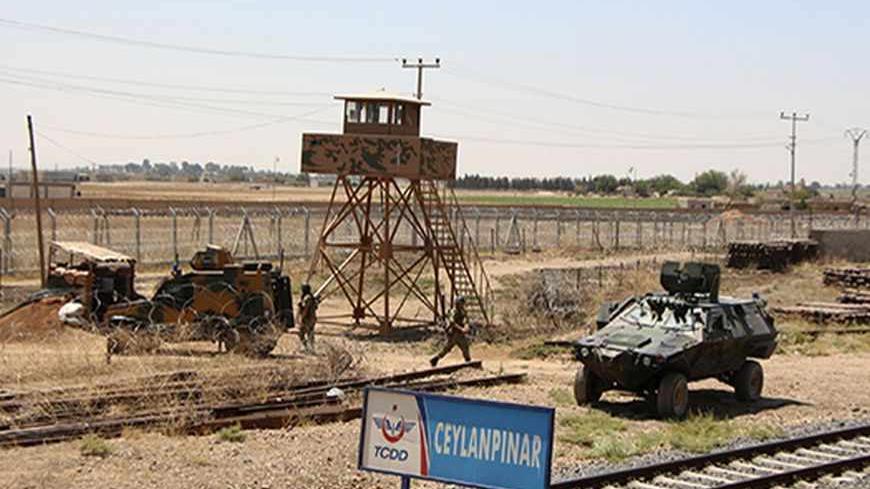 Turkish soldiers patrol on the Turkish-Syrian border in the town of Ceylanpinar in Sanliurfa province July 19, 2013. Kurdish militias have sought to consolidate their grip in northern Syria after exploiting the chaos of the country's civil war over the past year by seizing control of districts as President Bashar al-Assad's forces focused elsewhere. The clashes have reduced to the odd burst of gunfire, but days of heavy exchanges last month sent stray shells and bullets crashing onto the Turkish side. The T