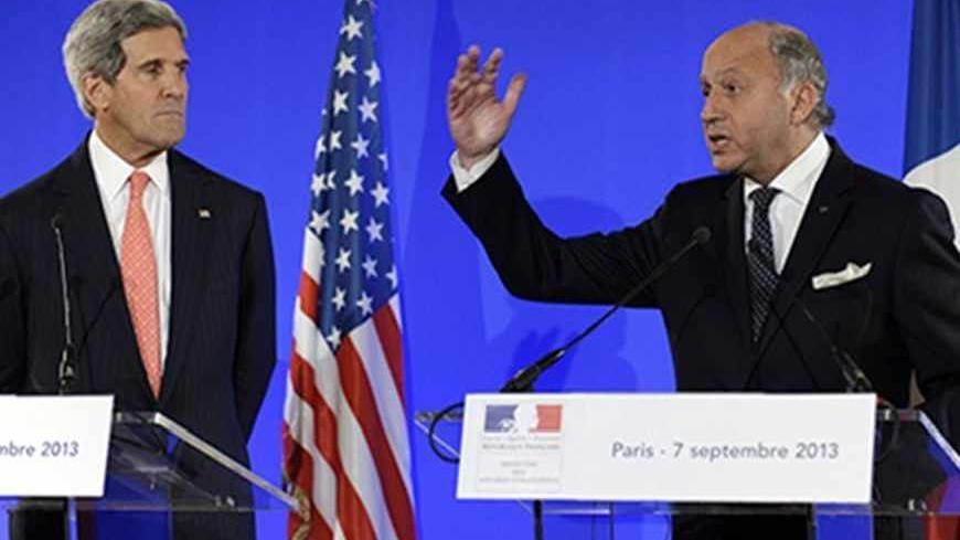 U.S. Secretary of State John Kerry and France's Foreign Minister Laurent Fabius (R) hold a news conference at the Ministry of Foreign Affairs in Paris September 7, 2013. U.S. President Barack Obama has made no decisions about waiting for a U.N. weapons inspectors' report on chemical arms use in Syria and he is keeping all his options open, Kerry said on Saturday.  REUTERS/Susan Walsh/Pool (FRANCE - Tags: POLITICS) - RTX13BSN