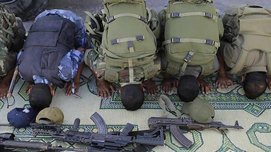 Members of Hamas security forces pray before a rally calling on Egyptian authorities to open the Rafah border crossing, at the crossing in the southern Gaza Strip September 17, 2013. Cairo closed the Rafah crossing, Gaza's main window to the world, completely last week after assailants crashed two explosive-laden cars into a security building adjacent to the border zone, killing six Egyptian soldiers. Ashraf al-Qidra, spokesman for the Hamas-run Gaza Health Ministry, said 1,000 patients a month required med
