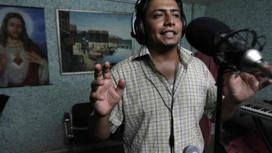 Baghdad, IRAQ: TO GO WITH AFP ARABIC STORY BY AHMAD AL-RUBAYE
Young Iraqi singer Hassan Hadi registers the songs of his new album at a studio in Baghdad, 14 July 2007. Unlike neighboring countries, singing became rare in Iraq due to the violence tearing apart the war plagued country. AFP PHOTO/AHMAD AL-RUBAYE (Photo credit should read AHMAD AL-RUBAYE/AFP/Getty Images)