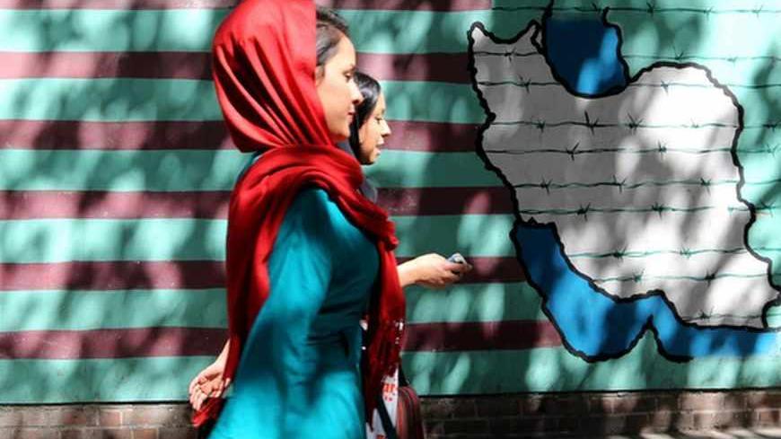Iranian women walk past a mural showing an interpretation of the Statue of Liberty bearing the face of a skull on the wall of the former US embassy in Tehran on September 25, 2013. Leaders from Iran and the United States have not met since the 1979 Islamic Revolution brought often open hostility to their contacts, particularly over Iran's contested nuclear program. AFP PHOTO/ATTA KENARE (Photo credit should read ATTA KENARE/AFP/Getty Images)