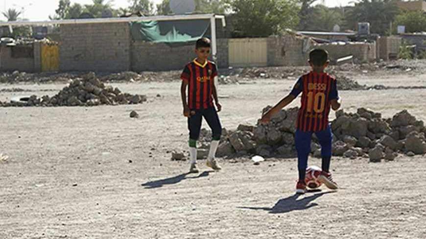 Boys play soccer in an abandoned soccer pitch in Baquba about 50 km (31 miles) northeast of Baghdad, August 6, 2013. Iraqis have endured extreme violence for years, but since the since the start of 2013 the intensity of attacks on civilians has dramatically increased, reversing a trend that had seen the country grow more peaceful. Attacks have spread to some of the few places left for public entertainment such as cafes and public soccer pitches, turning Baghdad into a giant fortified prison of concrete blas