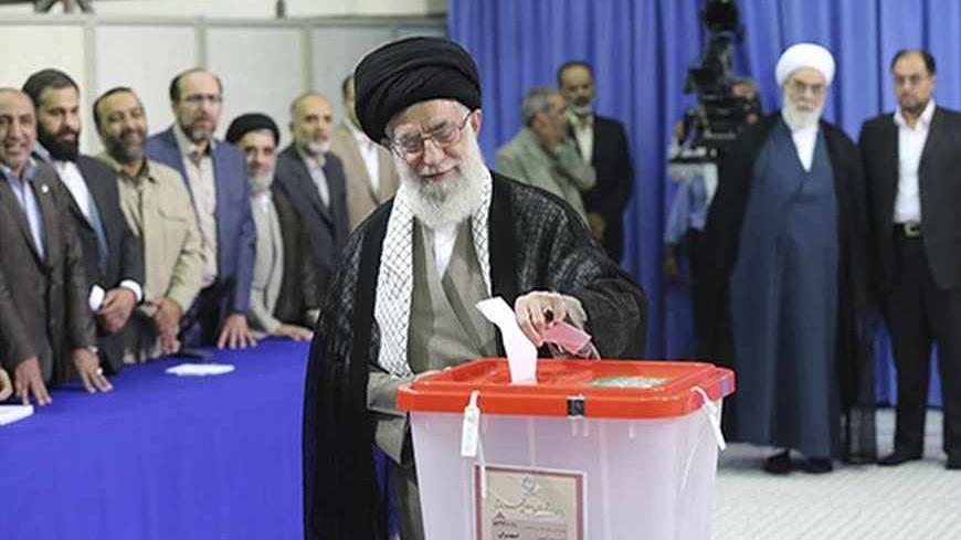 Iran's Supreme Leader Ayatollah Ali Khamenei casts his ballot at his office during the Iranian presidential election in central Tehran June 14, 2013. Iranians voted for a new president on Friday urged by Khamenei to turn out in force to discredit suggestions by arch foe the United States that the election would be unfair. REUTERS/Fars News/Hassan Mousavi  (IRAN - Tags: POLITICS ELECTIONS TPX IMAGES OF THE DAY) ATTENTION EDITORS - THIS IMAGE WAS PROVIDED BY A THIRD PARTY. FOR EDITORIAL USE ONLY. NOT FOR SALE