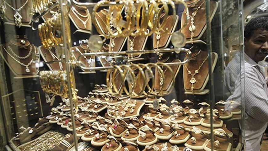 A worker stands in front of his gold jewellery shop at the market of Khan el-Khalili in Old Cairo October 10, 2012. Goldsmiths at the market say they are lacking customers and feeling unsafe, and are asking for a stronger security presence. Picture taken October 10, 2012. REUTERS/Amr Abdallah Dalsh  (EGYPT - Tags: BUSINESS SOCIETY) - RTR397KI