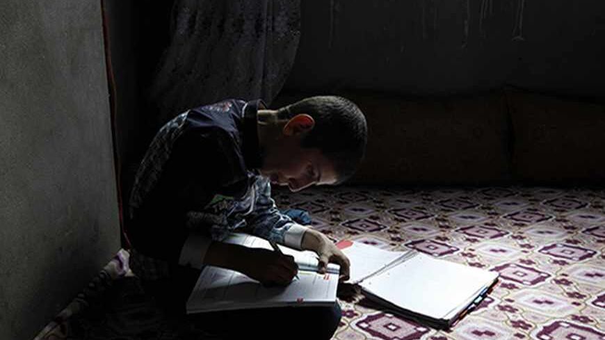 Ferhat Savun aged 11, works on his homework in his home in town of  Cizre in Sirnak province, near the border with Syria March 23, 2013. Turkey's fledgling peace process with the Kurdistan Workers Party (PKK) militant group is all over the headlines. After three decades of war, 40,000 deaths and a devastating impact on the local economy, everybody seems ready for peace. Pro-Kurdish politicians are focused on boosting minority rights and stronger local government for the Kurds, who make up about 20 percent o