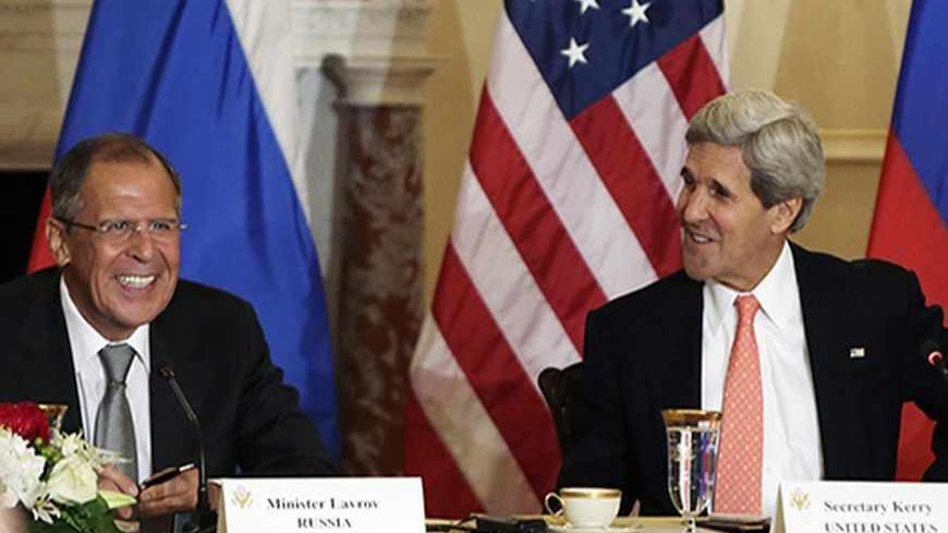 U.S. Secretary of State John Kerry smiles with Russia's Foreign Minister Sergey Lavrov (L) at a press briefing at the State Department in Washington before a day of talks August 9, 2013. U.S. and Russian officials will seek to maintain a working relationship when they meet in Washington on Friday even though the political mood between the two countries has hit one of its lowest points since the end of the Cold War. REUTERS/Gary Cameron (UNITED STATES - Tags: POLITICS) - RTX12F1G