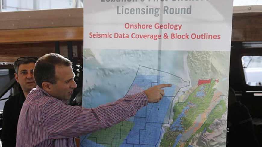 Caretaker Energy Minister Gebran Bassil points at a map during a tour of areas believed to have gas reserves, off Lebanon's coast near Beirut May 30, 2013.  Offshore seismic surveys suggest Lebanon has at least 30 trillion cubic feet in just a small fraction of its Mediterranean waters Bassil said. Lebanon has selected 46 international oil companies to bid to explore for gas off its coast, where survey ships have been assessing prospects after discoveries in waters off neighbouring Israel and Cyprus. Pictur