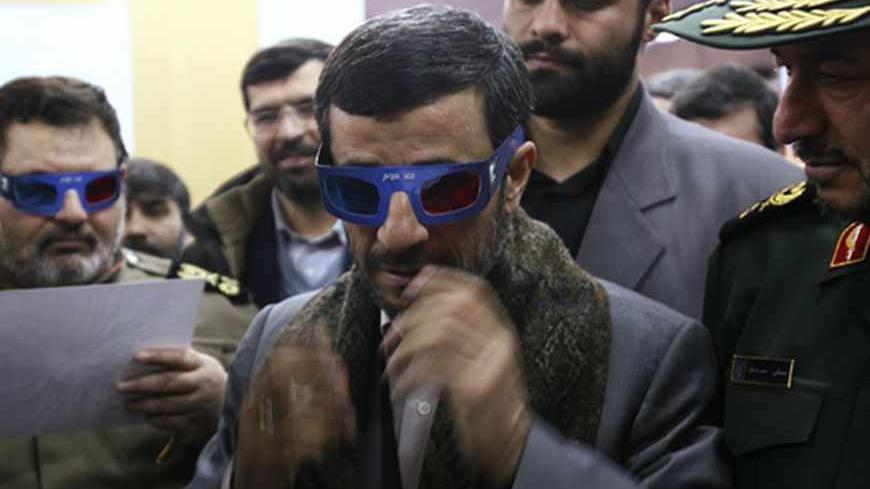 Iranian President Mahmoud Ahmadinejad wears 3-D glasses to watch a programme about an Iranian rocket during a visit to the control centre for Iran's space programme near Tehran February 4, 2008. Iran launched a rocket on Monday designed to send its first homemade research satellite into orbit in the next year, state television said, a move likely to add to Western concerns about Tehran's nuclear plans. REUTERS/Fars News (IRAN) also see GF2DXFSYXNAA - RTR1WNQL