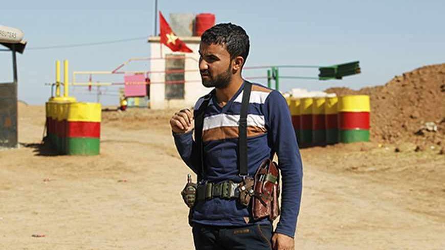 An officer of the Syrian Kurdish Democratic Union Party (PYD) stands guard near the Syrian-Iraq border October 31, 2012. Iraqi Kurdish President Masoud Barzani warned Kurds in Syria against being sucked into the "fires of discord," urging them to preserve Kurdish unity as tensions between rival factions threaten to spillover into violence. Syria's Kurds see the war ravaging their country as an unprecedented opportunity to gain the kind of freedoms enjoyed by their ethnic kin in neighbouring Iraq, where they