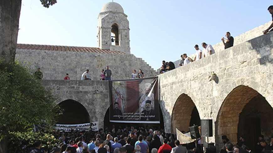A general view shows people attending a candle-lit vigil at the Balamand Monastery in Koura, near the north Lebanese city of Tripoli, to call for the release of bishops kidnapped in northern Syria two months ago, June 22, 2013. Greek Orthodox Patriarch John Yazigi led the candle-lit vigil on Saturday for Greek Orthodox archbishop Paul Yazigi and Syriac Orthodox archbishop Yohanna Ibrahim, appealing to their kidnappers to free them and urging Syrian security forces to do more to win their release. REUTERS/Om