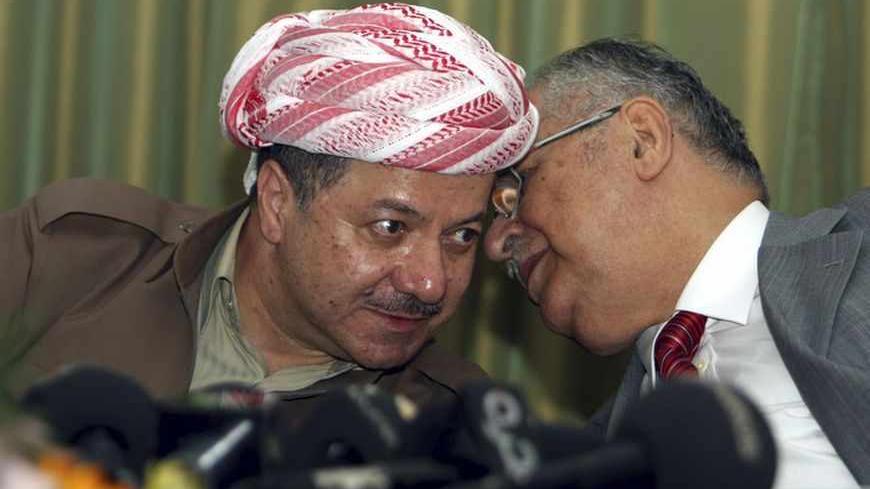 Iraqi President Jalal Talabani (R) speaks with Kurdish President Masoud Barazani (L) during his visit to Dokan, 290 km (180 miles) northeast of Baghdad July 29, 2009. Ruling parties in Iraqi Kurdistan will retain control of the Kurdish parliament after weekend polls, preliminary results showed on Wednesday. An opposition movement, campaigning against corruption and for political reforms, took a surprise 23.8 percent, electoral officials said in the Kurdish capital Arbil. REUTERS/Azad Lashkari (IRAQ POLITICS