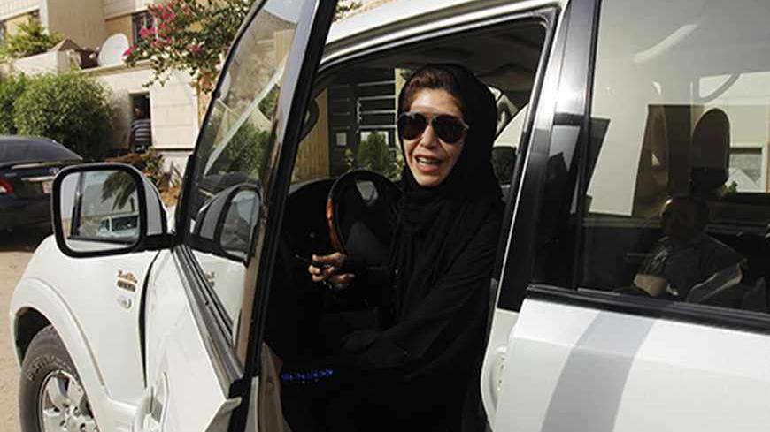 Female driver Azza Al Shmasani alights from her car after driving in defiance of the ban in Riyadh June 22, 2011. Saudi Arabia has no formal ban on women driving. But as citizens must use only Saudi-issued licences in the country, and as these are issued only to men, women drivers are anathema. An outcry at the segregation, which contributes to the general cloistering of Saudi women, has been fuelled by social media interest in two would-be female motorists arrested in May.REUTERS/Fahad Shadeed (SAUDI ARA