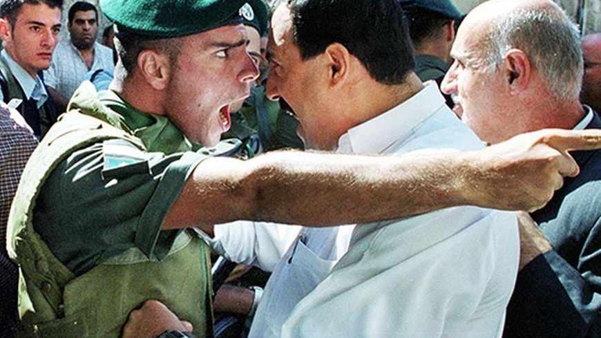 An Israeli Border Policeman and a Palestinian scream at each other face to face in the Old City of Jerusalem October 13, 2000 as the Palestinian is refused entry to the al-Aqsa mosque for Friday prayers. Israeli security forces prevented thousands of Palestinians from attending Friday prayers over concern for continued unrest and clashes following the prayers due to the increased tensions and fighting in the West Bank and Gaza Strip. REUTERS/Amit Shabi
JWH/WS/FMS - RTRBSE2