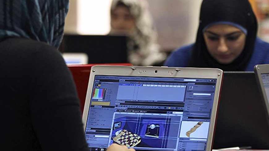 Young entrepreneurs work on their laptops at the Amman-based Oasis 500, a seed investment firm which finances start-up firms in the region's information technology sector, November 2, 2011. Across the Middle East and North Africa, the Arab Spring uprisings have hurt many businessmen. Economies have slowed sharply as political uncertainty deters investment, new governments focus on trying to restore social stability instead of reforming economic policy, and labour unrest disrupts production and drives up cos