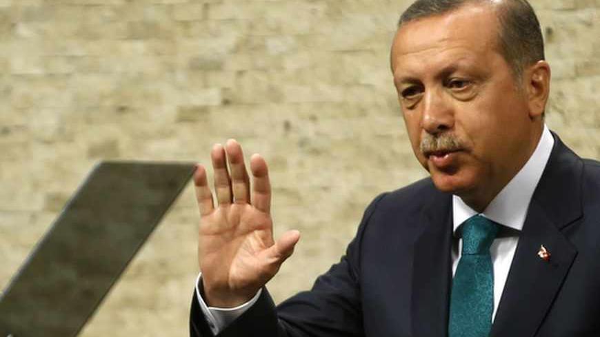 Turkish Prime Minister Tayyip Erdogan waves as he leaves a news conference in Ankara September 30, 2013. Turkey will end a ban that bars women from wearing the Islamic-style headscarf in state institutions, part of the government's long-awaited package of proposed human-rights reforms, Erdogan said on Monday in a major policy speech. The new rules will not apply to the judiciary or the military. Muslim but secular Turkey has long had tough restrictions on the garb worn by women working in state offices. Erd