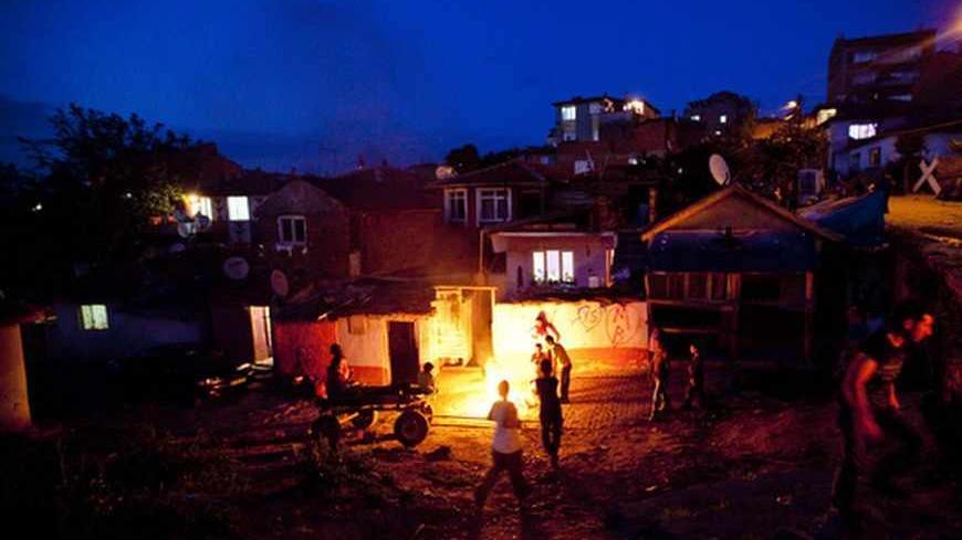 Turkish gypsies stand next to a fire during the celebration of the annual Spring Festival "Hidirellez", on May 5, 2013, 2013, in Edirne, south-western Turkey. Gypsies celebrate the beginning of the spring season according to their calendar. Hidirellez is celebrated as the day on which Prophets Hizir (Al-Khidr) and Ilyas (Elijah) met on earth. AFP PHOTO/GURCAN OZTURK (Photo credit should read GURCAN OZTURK/AFP/Getty Images)