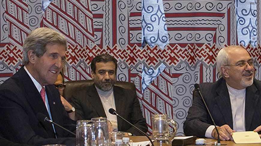 U.S. Secretary of State John Kerry (L) and Iran's Foreign Minister Mohammad Javad Zarif (R) are seated during a meeting of the foreign ministers representing the permanent five member countries of the United Nations Security Council, including Germany, at UN Headquarters in New York September 26, 2013.  Iran's new government began its first talks on its nuclear program with the United States and five other world powers on Thursday, with the Iranian foreign minister taking a seat next to U.S. Secretary of St