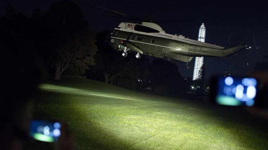 People with mobile phones film the Marine One while it takes off with U.S. President Barack Obama as he departs for Sweden and the G20 summit in Russia, from the White House in Washington September 3, 2013. Obama won the backing of key figures in the U.S. Congress, including Republicans, in his call for limited U.S. strikes on Syria to punish President Bashar al-Assad for his suspected use of chemical weapons against civilians. Obama will hold bilateral meetings with Chinese President Xi Jinping and French