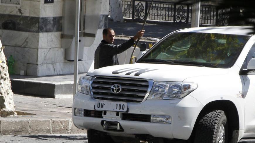 A U.N. vehicle returns to a hotel where experts from the Organisation for the Prohibition of Chemical Weapons (OPCW) are staying, in Damascus October 11, 2013. The global chemical weapons watchdog charged with overseeing destruction of Syria's chemical weapons stockpile during a civil war won the 2013 Nobel Peace Prize on Friday. The Organisation for the Prohibition of Chemical Weapons (OPCW), a relatively small organisation with a modest budget, dispatched its experts after a sarin gas attack killed more t
