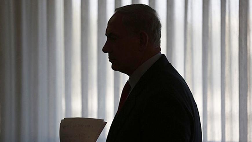 Israeli Prime Minister Benjamin Netanyahu is silhouetted as he arrives to deliver a statement to the media at the Knesset, Israeli parliament, in Jerusalem July 22, 2013. Netanyahu will seek formal cabinet backing for reviving U.S.-sponsored peace talks with the Palestinians, an Israeli official said, after pro-settler ministers threatened to try and thwart the initiative. REUTERS/Baz Ratner (JERUSALEM - Tags: POLITICS) - RTX11V4Y