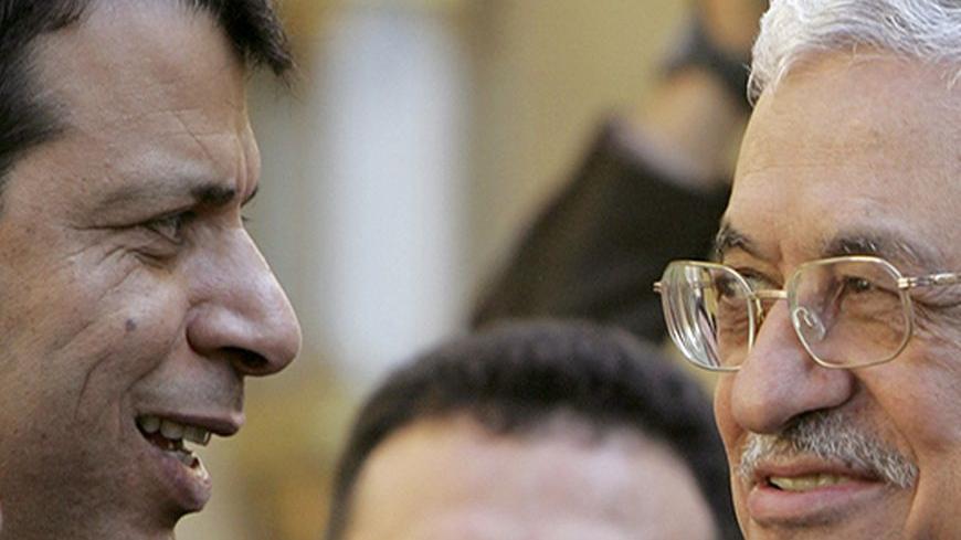 Palestinian President Mahmoud Abbas (R) talks to senior Fatah official Mohammad Dahlan after his meeting with Egypt's President Hosni Mubarak (not pictured) in Cairo February 10 2007. REUTERS/Tara Todras-Whitehill (EGYPT) - RTR1M950