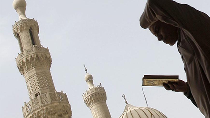 A man reads the Koran at Al-Azhar Mosque, where Sheikh Mohamed Sayed Tantawi was the Grand Imam, in the old Islamic area of Cairo March 10, 2010. Tantawi, the head of Egypt's most prestigious seat of Islamic learning al-Azhar died of a heart attack on Wednesday during a visit to Saudi Arabia, religious officials at al-Azhar said. He was 81. REUTERS/Amr Abdallah Dalsh (EGYPT - Tags: RELIGION) - RTR2BGGP