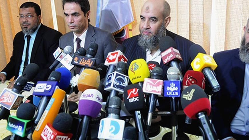 Younes Makhyoun (2nd R), head of the Salafist al-Nour Party attends a news conference with Presidential Media Advisor and spokesman Ahmed al-Muslimani (2nd L) at the party's headquarters in Cairo August 28, 2013. During the conference, Makhyoun stated that the Egyptian armed forces are a red line and reiterated al-Nour's support of the army's roadmap back to democracy, according to local media. Picture taken August 28, 2013.  REUTERS/Stringer  (EGYPT - Tags: POLITICS MEDIA) - RTX12ZWG