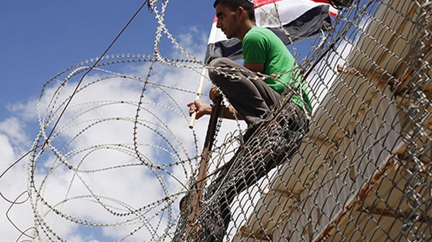 A Palestinian youth waves an Egyptian flag as he takes part in a rally calling on Egyptian authorities to open the Rafah crossing, outside the crossing in the southern Gaza Strip September 16, 2013. Cairo closed the Rafah crossing, Gaza's main window to the world, completely last week after assailants crashed two explosive-laden cars into a security building adjacent to the border zone, killing six Egyptian soldiers. Ashraf al-Qidra, spokesman for the Hamas-run Gaza Health Ministry, said 1,000 patients a mo
