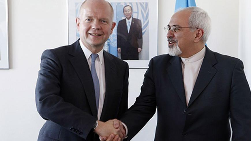 British Foreign Minister William Hague (L). shakes hands with Iran's Foreign Minister Mohammad Javad Zarif at the beginning of their bilateral meeting at the United Nations in New York September 23, 2013. REUTERS/Jason DeCrow/Pool (UNITED STATES - Tags: POLITICS) - RTX13X4G