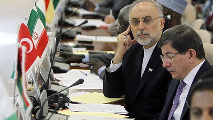 Iranian Foreign Minister Ali Akbar Salehi (L) looks past his Turkish counterpart Ahmet Davutoglu (2nd R) during the opening of a ministerial meeting in the Saudi Red Sea city of Jeddah, by the Organisation of Islamic Cooperation (OIC) on May 13, 2013. The OIC urged its member states to make generous contributions at this week's main donors conference on Mali to be held in Brussels, which aims to raise funds to repair the damage caused by the war against Islamists in the African country. AFP PHOTO/STR       