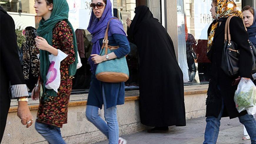 Iranian women, wearing jeans, shop in Tehran on October 7, 2013. A campaign launched by young Iranians on internet networking sites Facebook and Twitter were mocking Israeli President Benjamin Netayahu following his comments during an interview diffused on October 5, in which he implied there is a supposed ban on wearing jeans and listening to Western music in the Islamic Republic. AFP PHOTO/ATTA KENARE        (Photo credit should read ATTA KENARE/AFP/Getty Images)