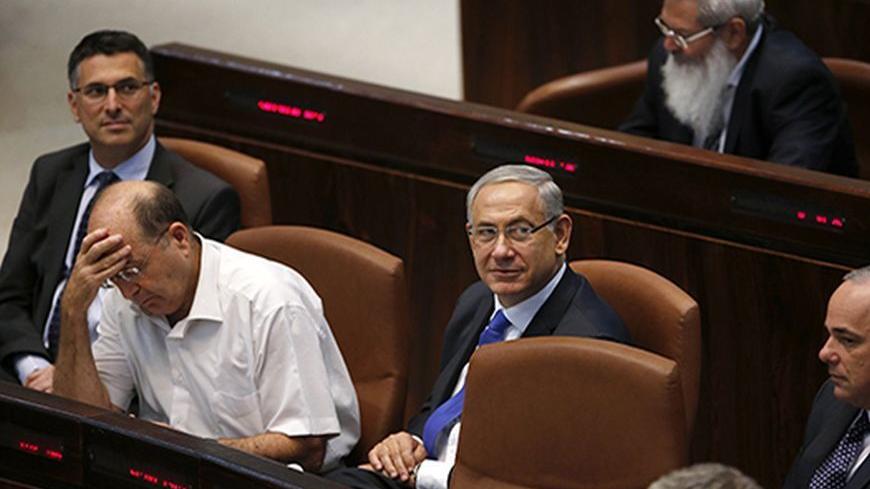 Israel's Prime Minister Benjamin Netanyahu (C) sits after speaking at the opening of the winter session of the Knesset, the Israeli parliament, in Jerusalem October 14, 2013. REUTERS/Ronen Zvulun (JERUSALEM - Tags: POLITICS) - RTX14AZX