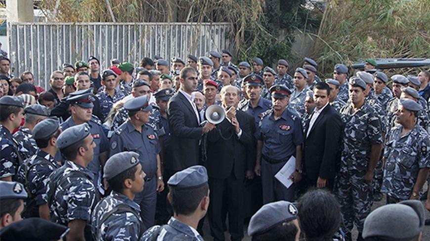 Lebanese Interior Minister Marwan Charbel (C) speaks to soldiers in Beirut's southern suburbs September 23, 2013. Lebanese security personnel were deployed today in the southern suburbs of Beirut, part of a move to take over the checkpoints set up by Hezbollah after recent car bombings targeted the area, according to the local media. REUTERS/Sharif Karim (LEBANON - Tags: POLITICS CIVIL UNREST) - RTX13WWZ